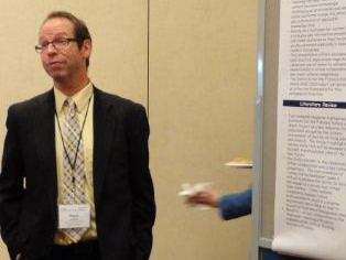 School of Education alum Dr. Ralph Charlton presenting his poster at the CHEP 2013 at Virginia Tech